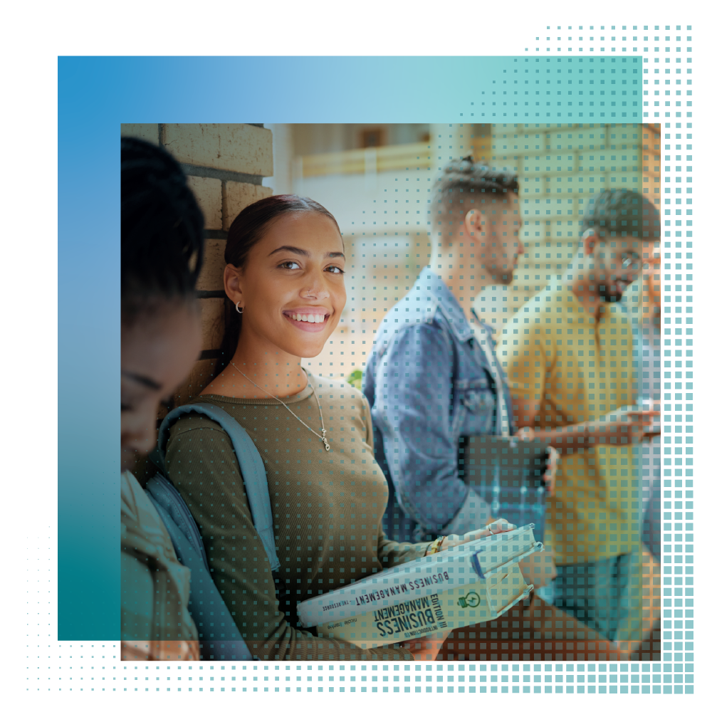 Students smiling and holding textbooks
